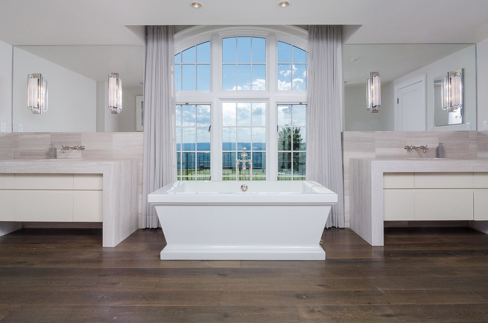 Photo of a large transitional master bathroom in San Francisco with flat-panel cabinets, beige cabinets, a freestanding tub, gray tile, grey walls, dark hardwood floors, an integrated sink, brown floor and beige benchtops.