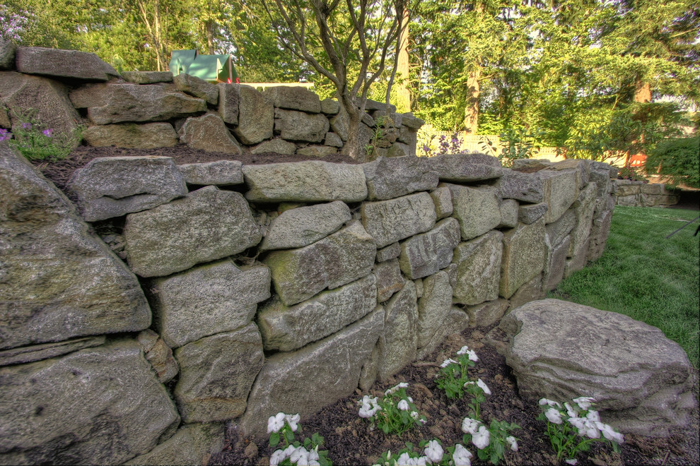 Photo of a traditional sloped garden in Portland with a retaining wall.