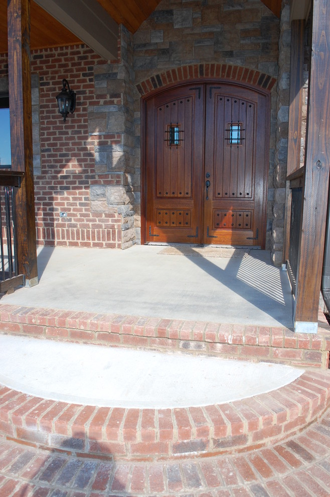 Inspiration for a rustic brown three-story brick exterior home remodel