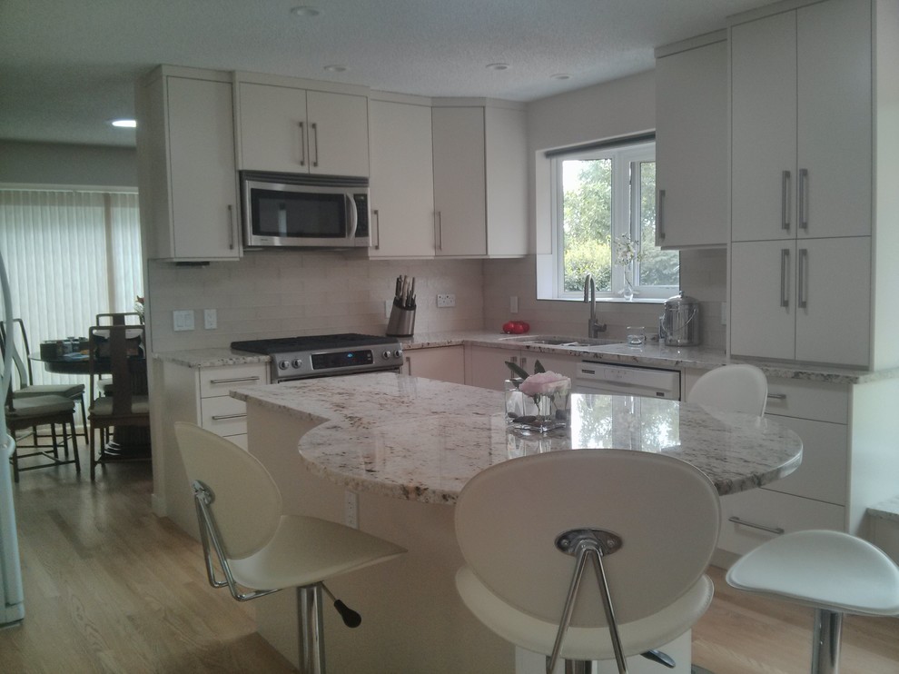 Example of a transitional kitchen design in Calgary