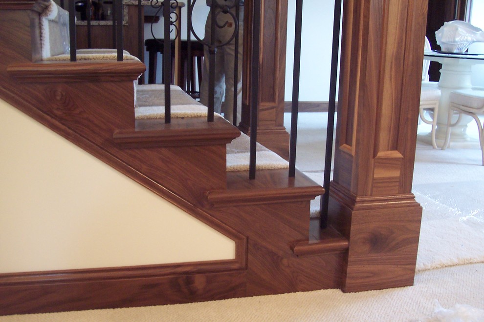 Design ideas for a mid-sized traditional wood u-shaped staircase in Minneapolis with wood risers.