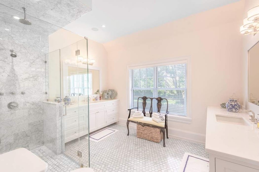Photo of an expansive transitional master bathroom in New York with beaded inset cabinets, white cabinets, an open shower, a one-piece toilet, beige tile, marble, white walls, marble floors, an undermount sink, quartzite benchtops, white floor, a hinged shower door and white benchtops.