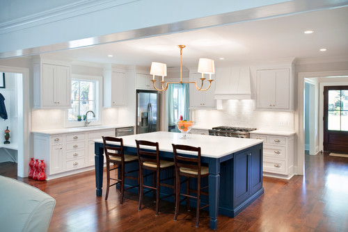 Gorgeous bright kitchen with a dark blue island, great color!