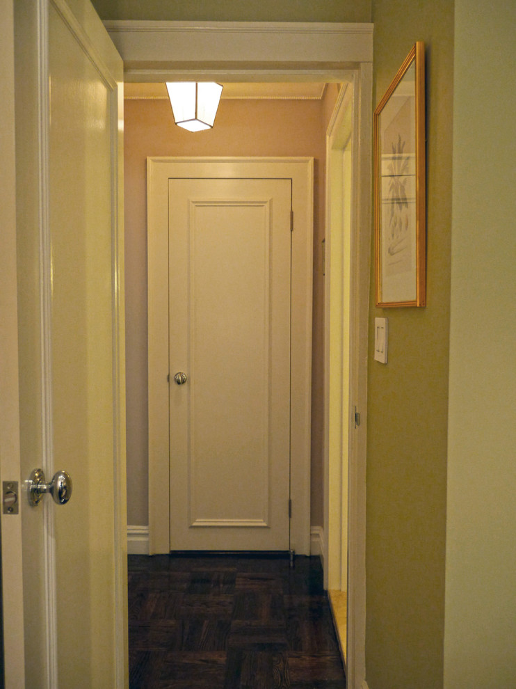 Small contemporary hallway in New York with multi-coloured walls and dark hardwood floors.