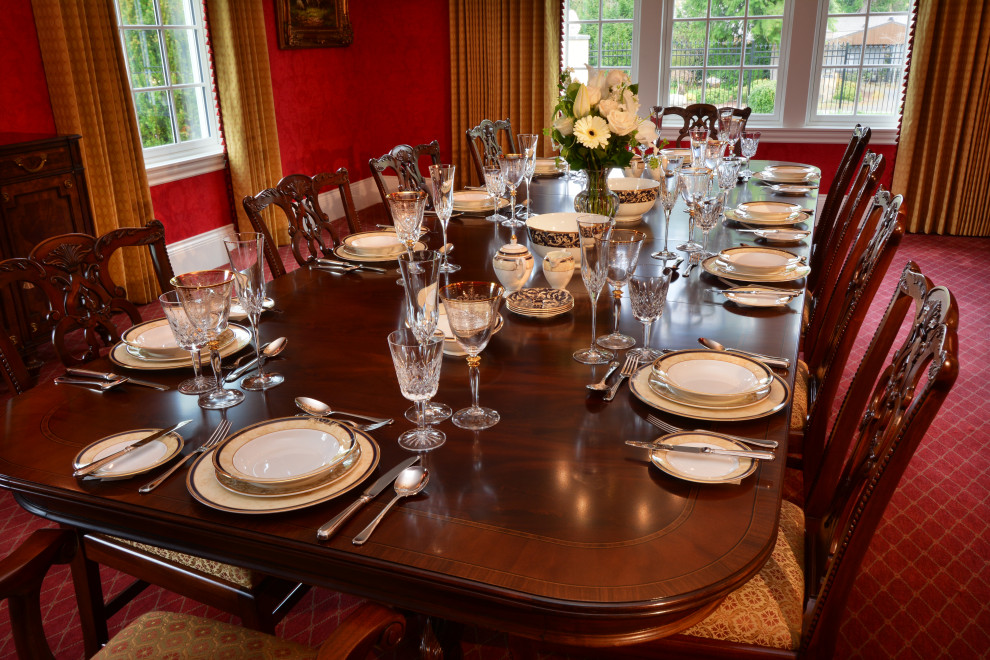 Photo of a mid-sized traditional separate dining room in Seattle with red walls, carpet, no fireplace and red floor.