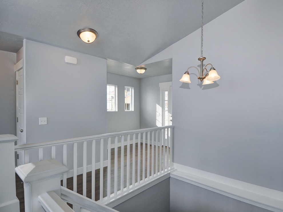 Photo of a small arts and crafts foyer in Salt Lake City with grey walls, laminate floors, a single front door and a white front door.