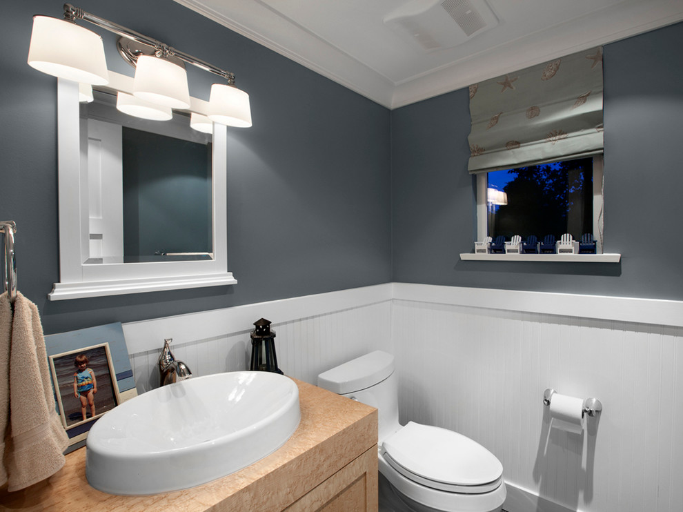 Photo of a small transitional powder room in Vancouver with a drop-in sink, recessed-panel cabinets, light wood cabinets, wood benchtops, a two-piece toilet, medium hardwood floors, grey walls and brown benchtops.
