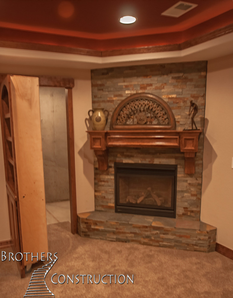 Inspiration for a mid-sized traditional fully buried basement in Denver with beige walls, carpet and a standard fireplace.