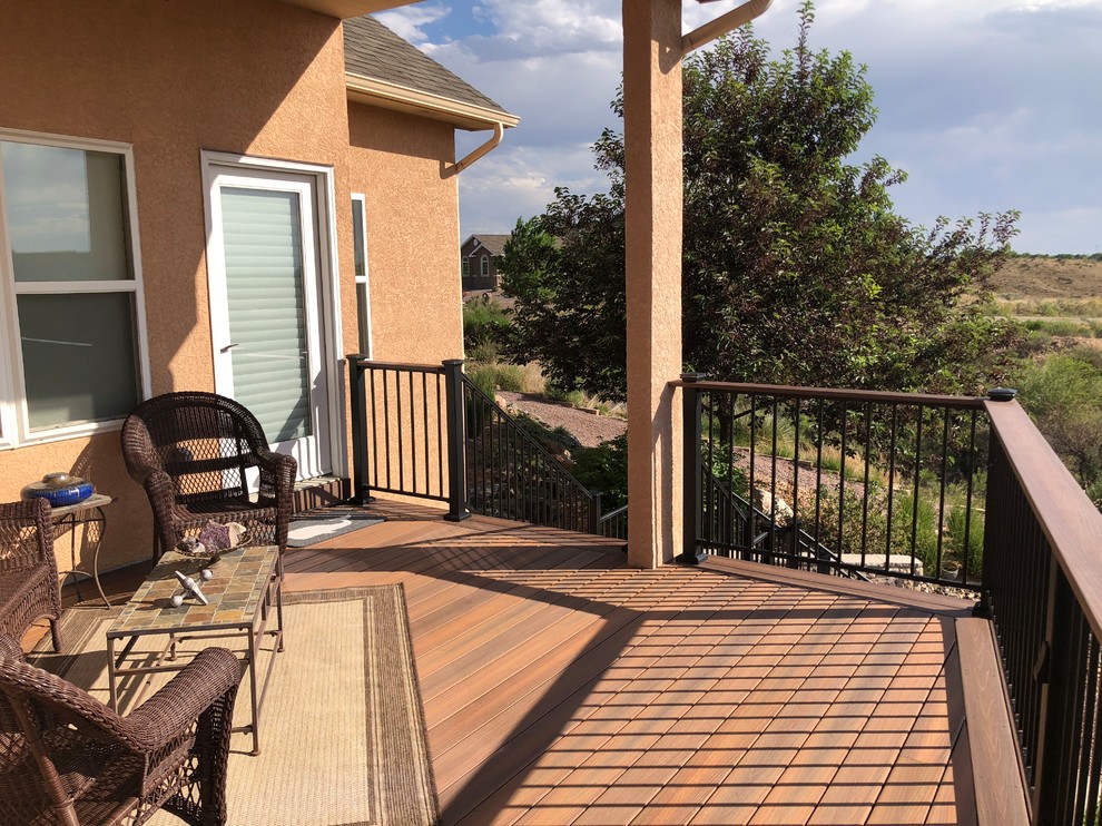 Example of a large transitional backyard deck design in Denver