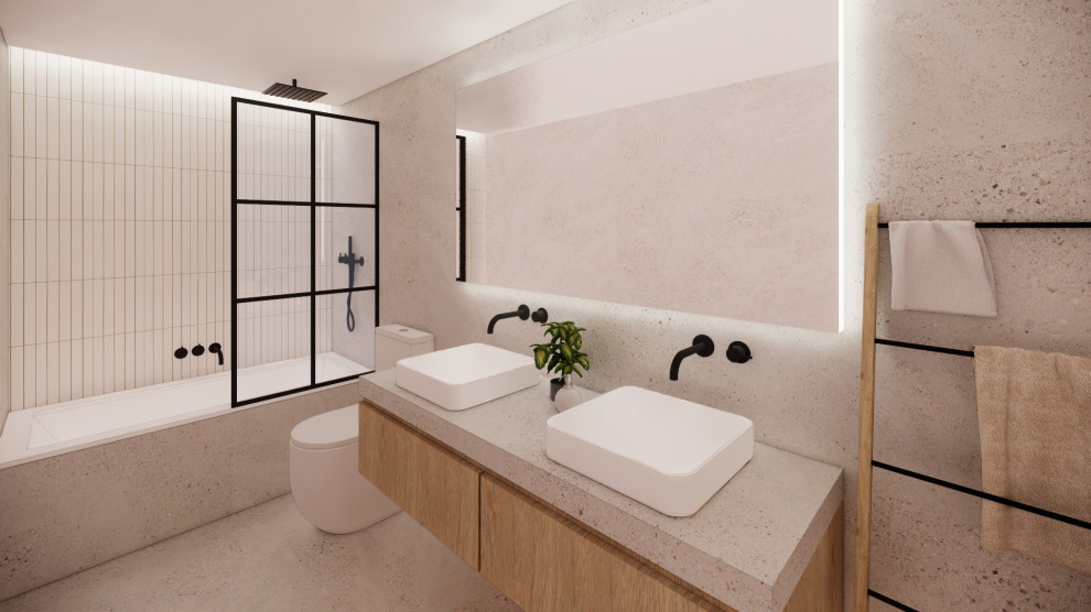 This is an example of a mid-sized industrial master bathroom in Barcelona with flat-panel cabinets, white cabinets, a drop-in tub, gray tile, grey walls, ceramic floors, a vessel sink, terrazzo benchtops, grey benchtops, a double vanity and a built-in vanity.