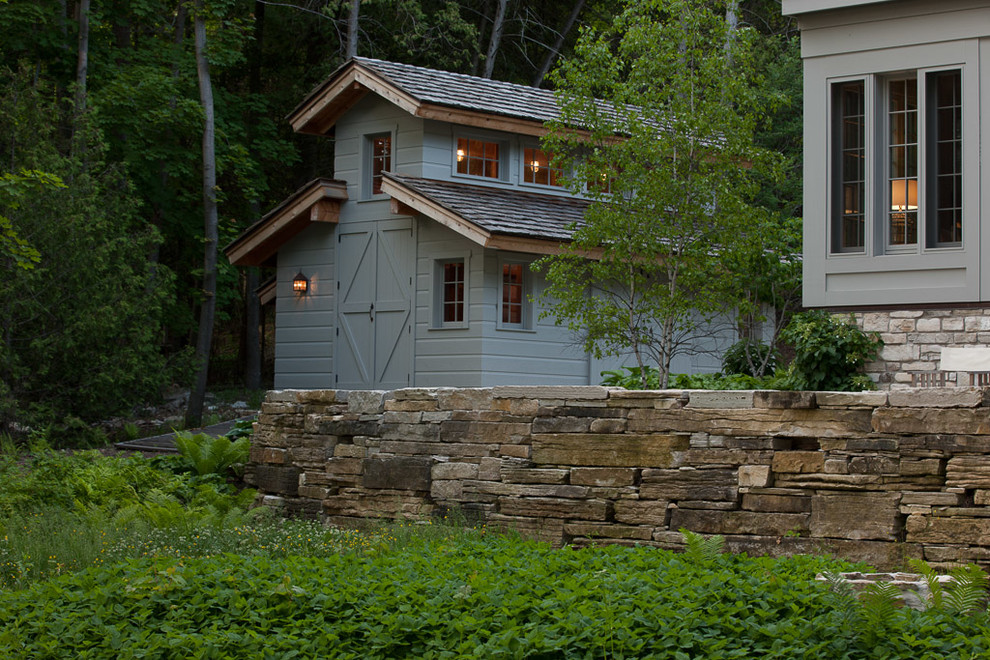Design ideas for a large rustic partial sun backyard stone retaining wall landscape for summer.
