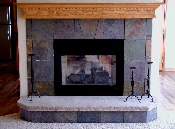 Example of a mountain style home design design in Denver with a two-sided fireplace and a stone fireplace