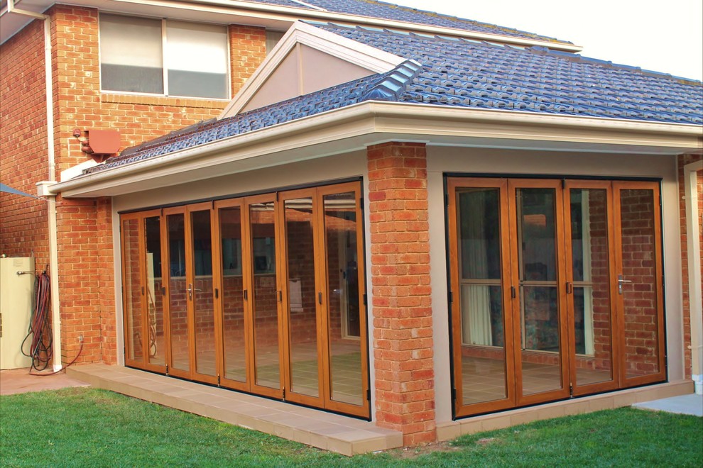Photo of a traditional sunroom in Melbourne with porcelain floors and a standard ceiling.