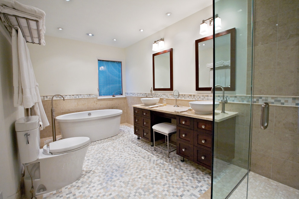 Design ideas for a large contemporary master bathroom in Bridgeport with a vessel sink, furniture-like cabinets, dark wood cabinets, marble benchtops, a freestanding tub, a curbless shower, a two-piece toilet, beige tile, porcelain tile, white walls and mosaic tile floors.