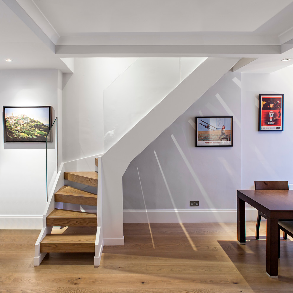 Design ideas for a contemporary staircase in London with glass railing.