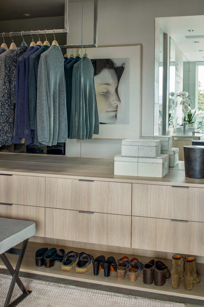 Inspiration for a large modern women's walk-in wardrobe in Denver with flat-panel cabinets, beige cabinets, ceramic floors and grey floor.