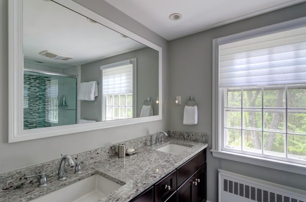 Design ideas for a large traditional 3/4 bathroom in Boston with recessed-panel cabinets, black cabinets, an alcove tub, a shower/bathtub combo, pink walls, ceramic floors, a drop-in sink, solid surface benchtops, beige floor and grey benchtops.
