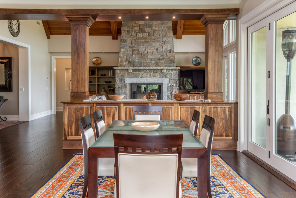 Photo of a mid-sized traditional kitchen/dining combo in Other with beige walls, dark hardwood floors, no fireplace and brown floor.