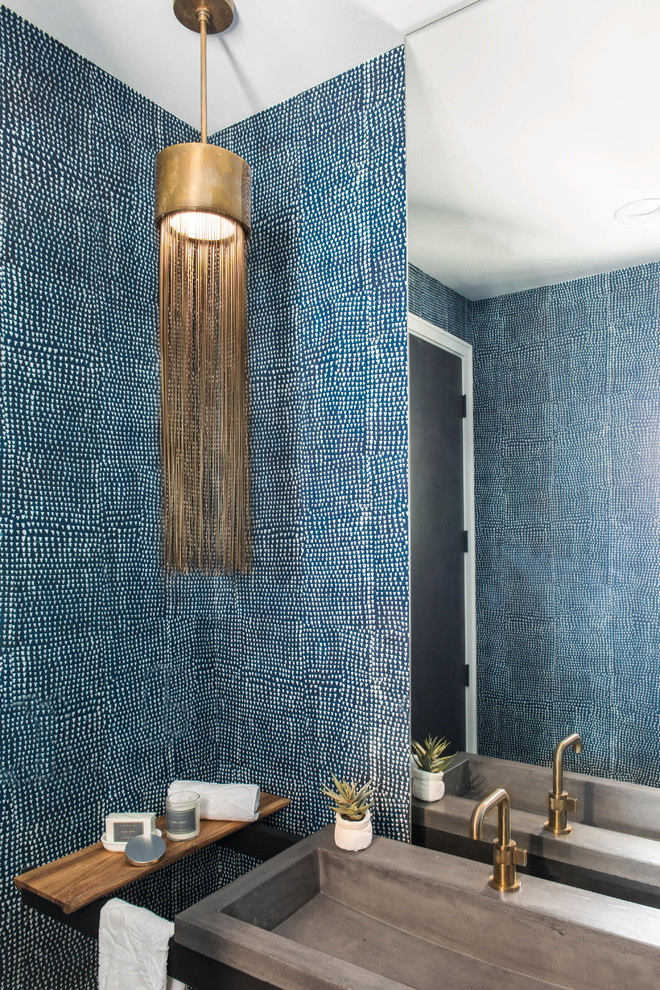 Contemporary powder room in Austin with blue walls and an integrated sink.