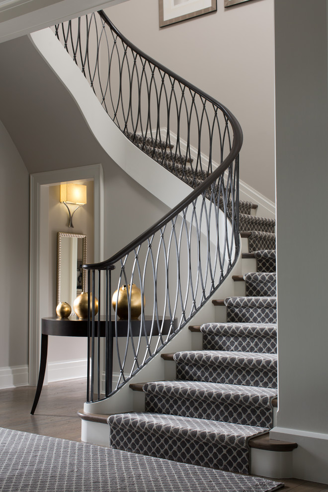 Photo of a transitional wood curved staircase in Baltimore with painted wood risers.