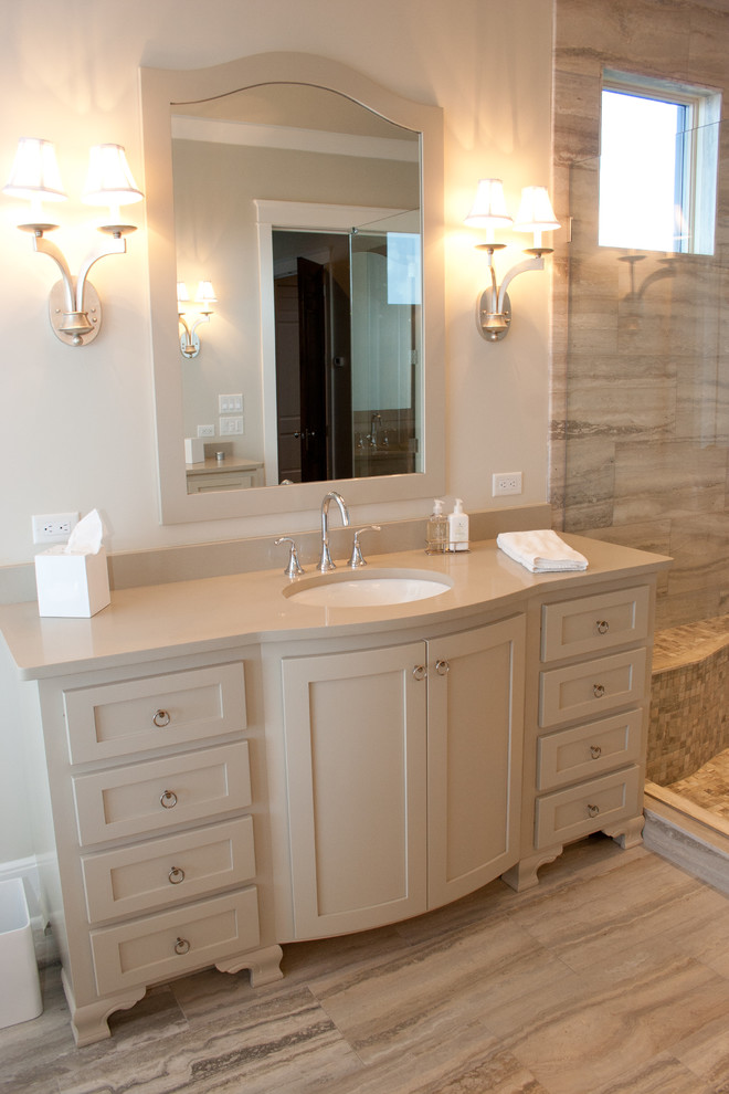 This is an example of a large beach style master bathroom in Atlanta with an undermount sink, furniture-like cabinets, beige cabinets, a freestanding tub, a corner shower, gray tile and grey walls.