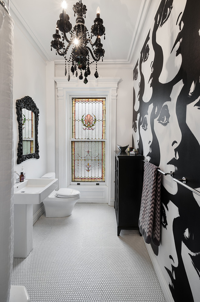This is an example of an eclectic bathroom in New York with multi-coloured walls and mosaic tile floors.