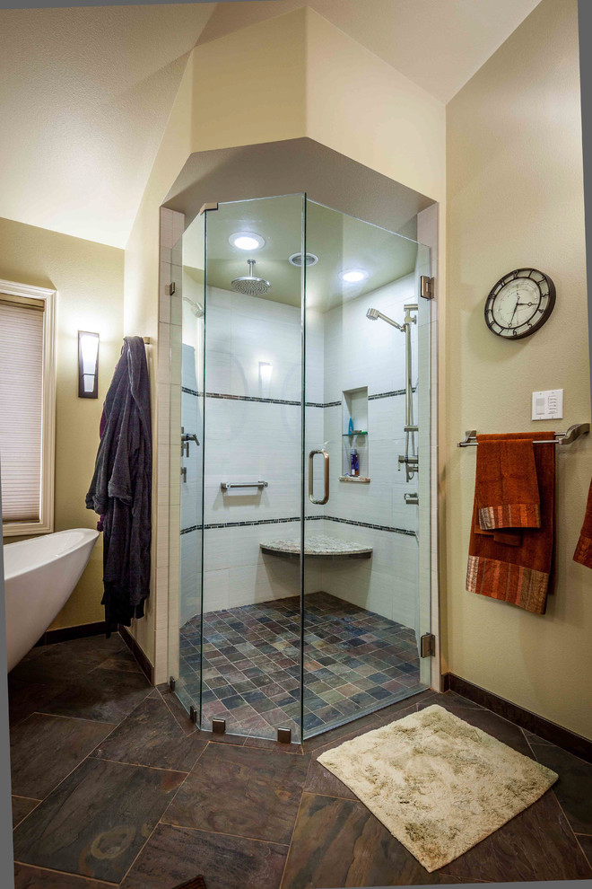 Photo of a large transitional master bathroom in Seattle with a drop-in sink, glass-front cabinets, medium wood cabinets, granite benchtops, a freestanding tub, a corner shower, a two-piece toilet, beige tile, ceramic tile, green walls and slate floors.