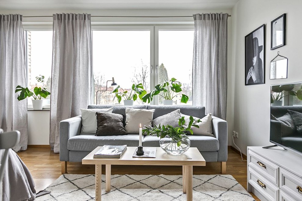Design ideas for a scandinavian living room in Stockholm with white walls.