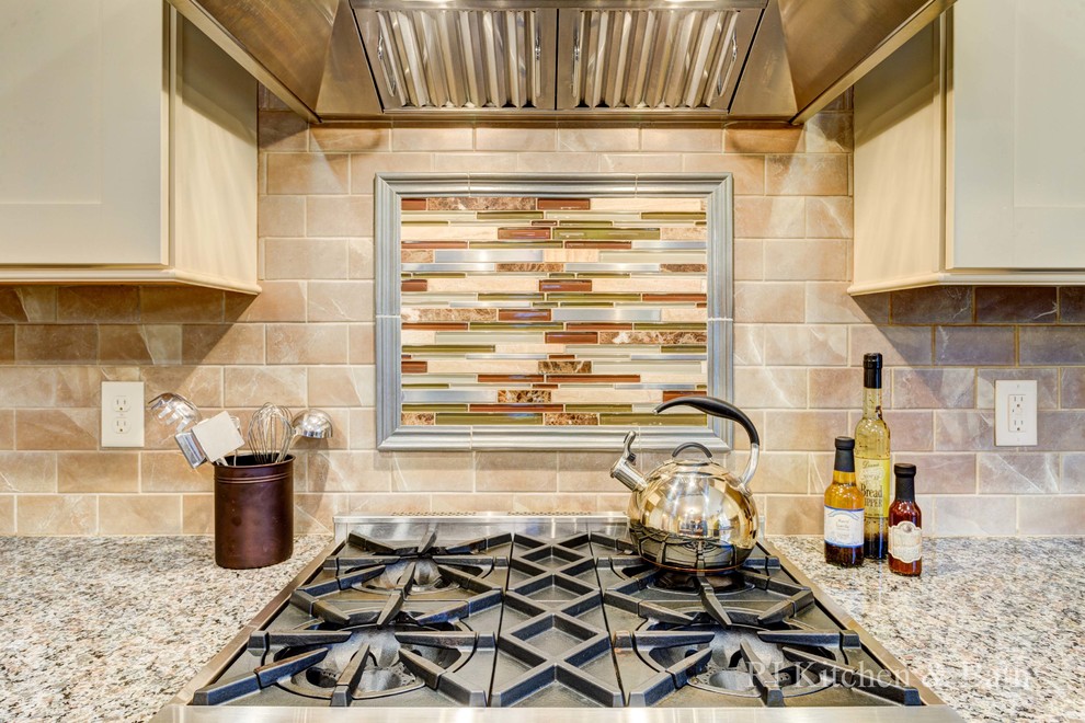 Inspiration for a large transitional u-shaped light wood floor eat-in kitchen remodel in Providence with an undermount sink, shaker cabinets, beige cabinets, granite countertops, brown backsplash, porcelain backsplash, stainless steel appliances and an island
