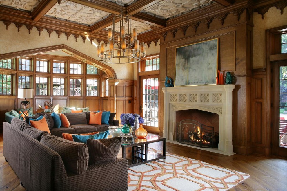This is an example of a traditional living room in New York with beige walls, dark hardwood floors and a standard fireplace.
