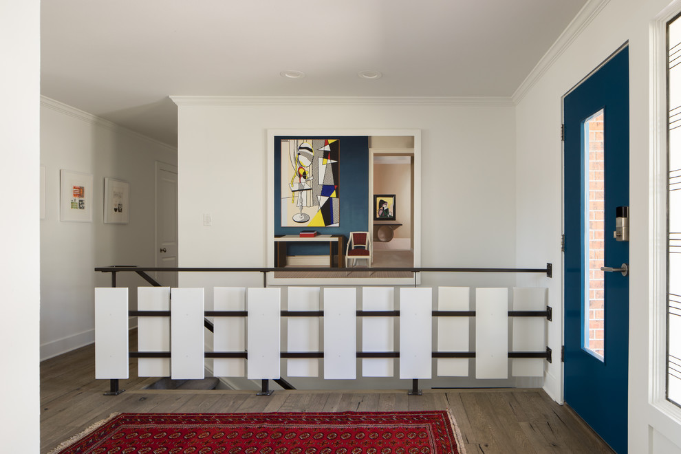 This is an example of a mid-sized midcentury foyer in Denver with white walls, light hardwood floors, a single front door, a blue front door and beige floor.