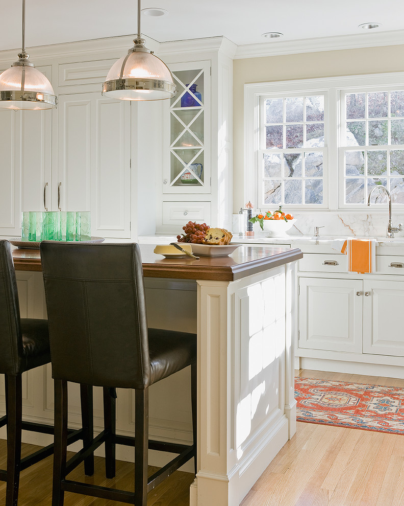 Inspiration for a traditional kitchen in Boston with wood benchtops.
