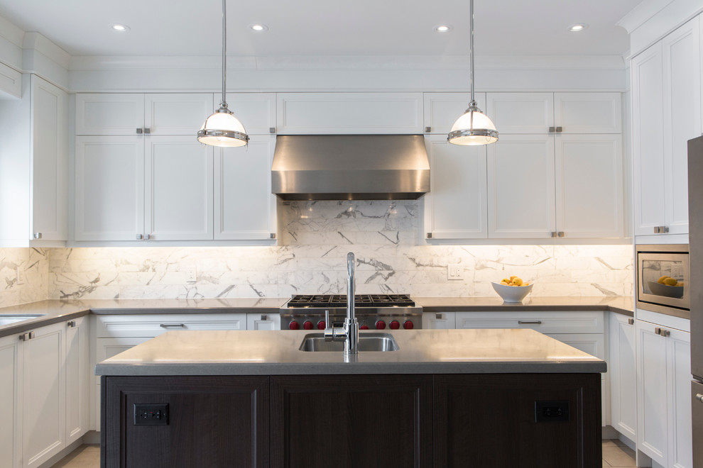 Eat-in kitchen - mid-sized transitional u-shaped porcelain tile eat-in kitchen idea in Toronto with an undermount sink, recessed-panel cabinets, white cabinets, quartz countertops, white backsplash, stone tile backsplash, stainless steel appliances and an island