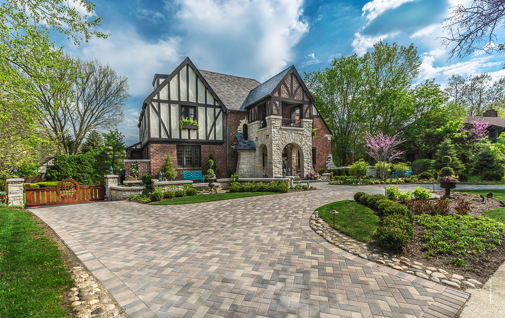 Inspiration for a large transitional multicolored two-story brick house exterior remodel in Chicago with a hip roof and a shingle roof