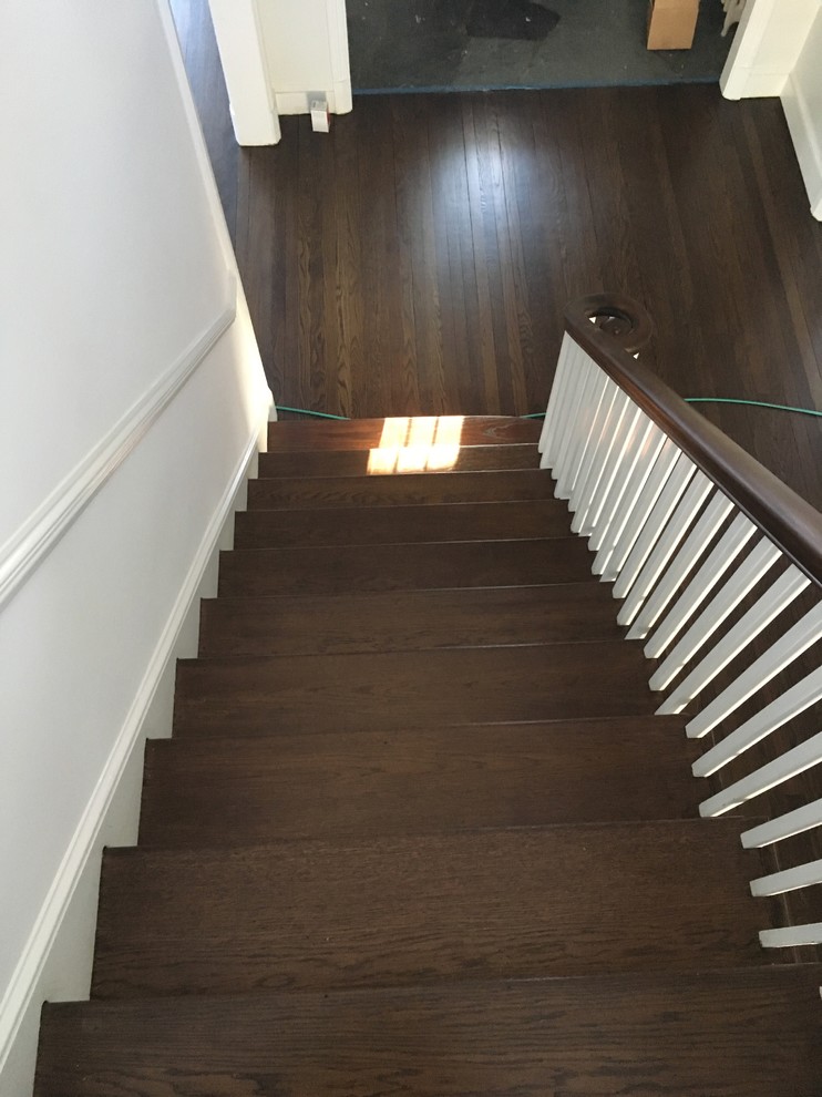 Mid-sized traditional wood staircase in New York with wood risers.