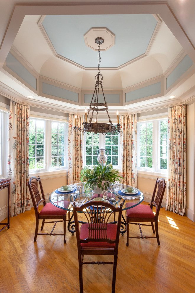 Traditional dining room in Other with beige walls, medium hardwood floors and brown floor.