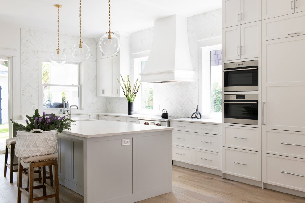 Transitional single-wall kitchen photo in Jacksonville with raised-panel cabinets, white backsplash and marble backsplash