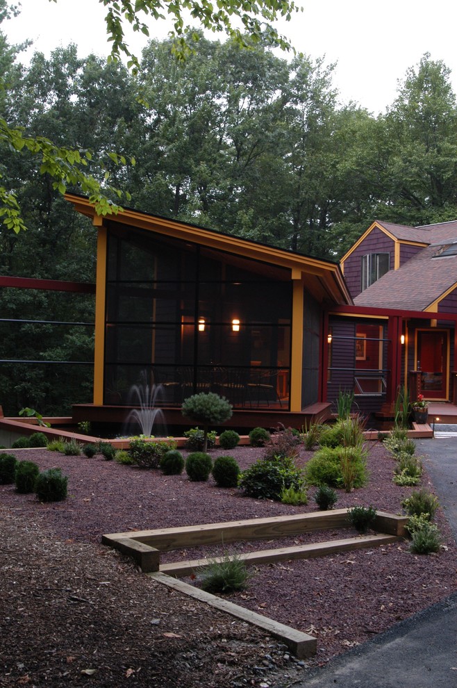 This is an example of a small midcentury one-storey exterior in Boston with wood siding and a shed roof.