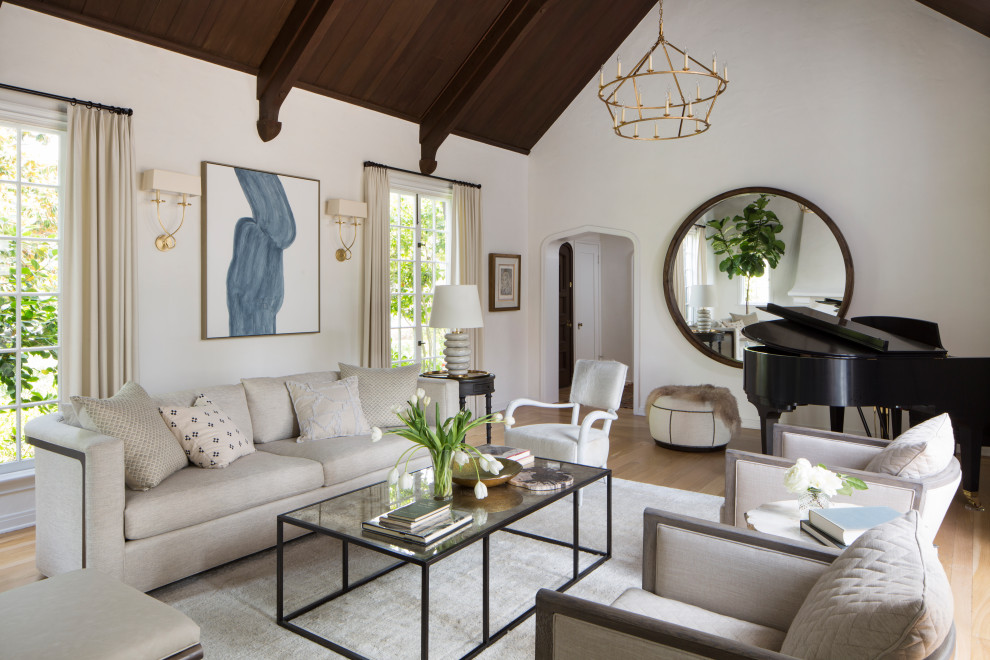Photo of a mid-sized transitional open concept living room in Los Angeles with a music area, white walls, medium hardwood floors, no fireplace, no tv and brown floor.