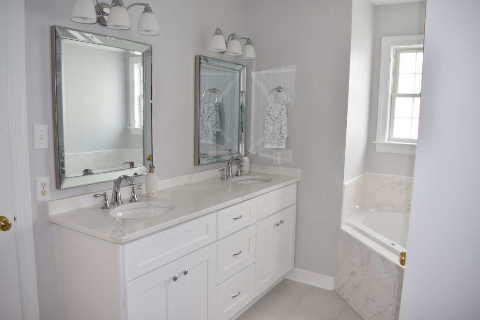 Design ideas for a large traditional master bathroom in Richmond with shaker cabinets, white cabinets, a corner tub, a corner shower, gray tile, grey walls, an undermount sink, quartzite benchtops, grey floor, a hinged shower door, white benchtops, a double vanity and a built-in vanity.