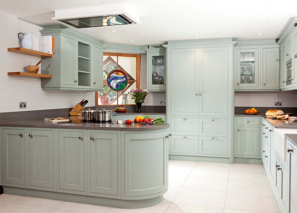 This is an example of a country u-shaped kitchen in Other with a farmhouse sink, shaker cabinets, green cabinets and a peninsula.