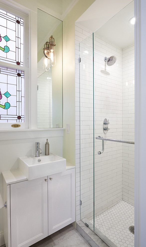 Inspiration for a small traditional master bathroom in San Francisco with recessed-panel cabinets, white cabinets, engineered quartz benchtops, an alcove shower, white tile, subway tile, green walls, marble floors and a vessel sink.