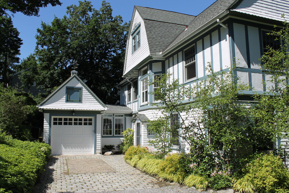Inspiration for a mid-sized traditional three-storey white exterior in New York with wood siding and a gable roof.