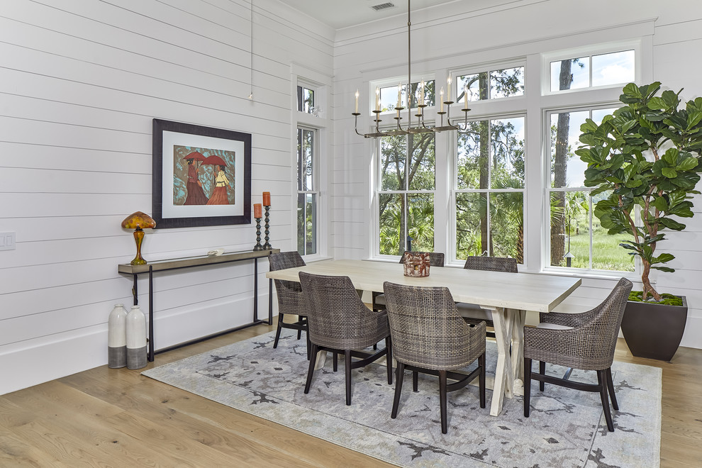 Mid-sized beach style kitchen/dining combo in Charleston with medium hardwood floors, brown floor and white walls.