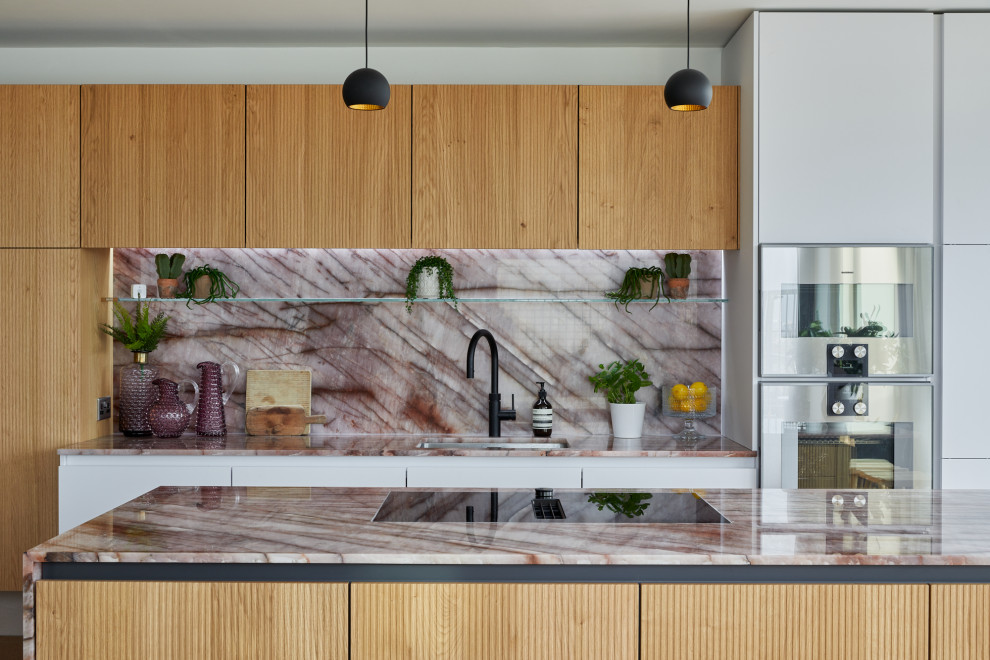 Example of a large trendy single-wall open concept kitchen design in London with an island