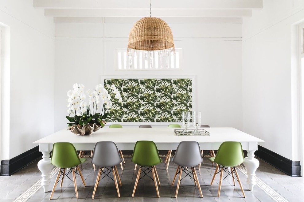 Inspiration for a tropical dining room in Singapore with white walls and grey floor.