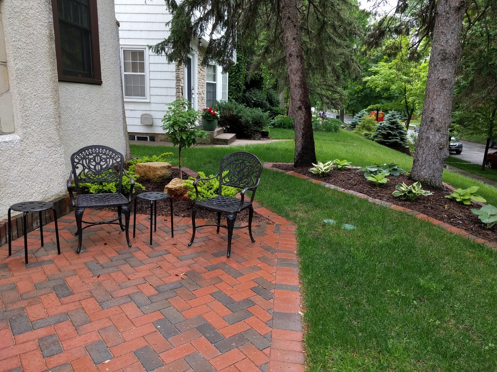 Mid-sized traditional backyard patio in Minneapolis with a fire feature, concrete pavers and no cover.