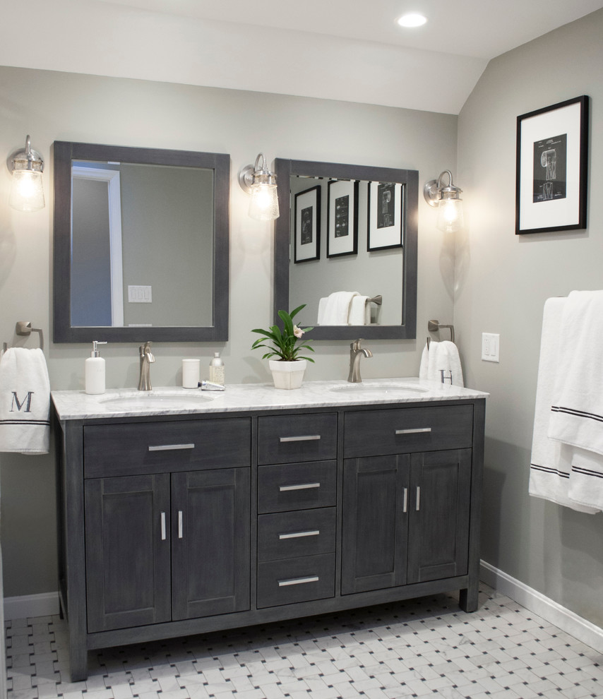 Mid-sized contemporary bathroom in Burlington with recessed-panel cabinets, distressed cabinets, an alcove tub, an alcove shower, a two-piece toilet, white tile, porcelain tile, grey walls, porcelain floors, marble benchtops and an undermount sink.