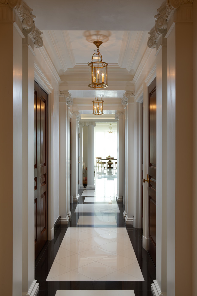 Traditional hallway in Miami with white walls and marble floors.