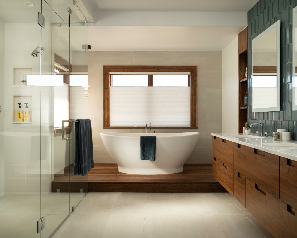 Inspiration for a large contemporary master bathroom in Denver with flat-panel cabinets, brown cabinets, gray tile, ceramic tile, white walls, an undermount sink, a hinged shower door, white benchtops, a double vanity, a floating vanity, a freestanding tub, porcelain floors and quartzite benchtops.